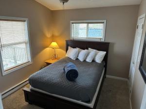 a bedroom with a bed with a hat on it at Tree House , Bagnell Dam area in Lake Ozark