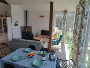 a living room with a table and a couch at O Salgueiral in Castro Caldelas