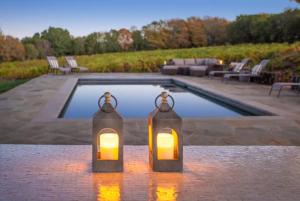 a couple of lanterns sitting next to a swimming pool at Exclusive Wine Country Estate - The Haven in Healdsburg