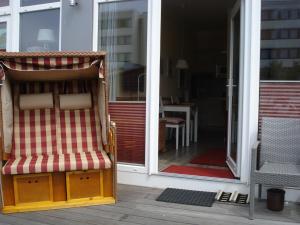 an open door with a chair on a porch at Koje "neu" in Burgtiefe auf Fehmarn 