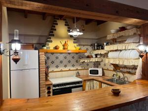 eine Küche mit einem weißen Kühlschrank und einer Spüle in der Unterkunft Cortijo los Vélez in Vélez-Blanco