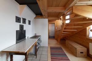 a kitchen with wooden ceilings and a wooden table at Nuessli in Wildhaus