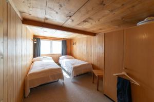 a room with two beds and a window at Nuessli in Wildhaus