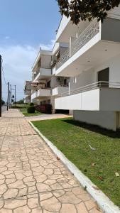 a building with a walkway in front of it at Cozy Nights in Messini