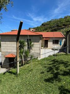 a house with a fence in front of it at Casas do Monte in Resende