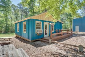 a blue tiny house in the woods at Quiet Hemphill Cabin Retreat Near Toledo Bend Lake in Hemphill