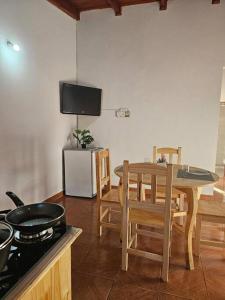 a kitchen with a table and chairs and a stove at Encantador depto cerca Terminal in Posadas