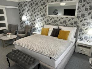 a bedroom with a large bed with yellow pillows at EFIPA Glamour Apartments in Pilsen
