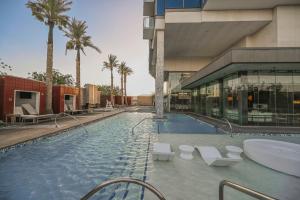 a swimming pool in a building with palm trees at StripViewSuites at Palms Place in Las Vegas