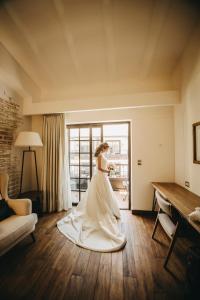 a bride in a wedding dress standing in a room at Sonesta Posadas del Inca - Valle Sagrado Yucay Urubamba in Urubamba