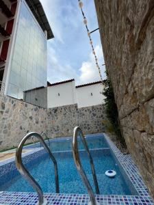 a swimming pool with two metal rails next to a building at Terra Imperial in Chachapoyas