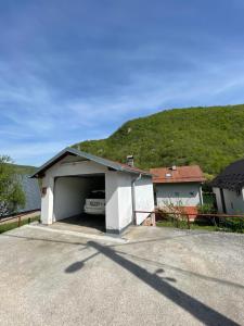 a garage with a car sitting inside of it at 069 Riverside Vikendica - Banja Luka in Rekavice