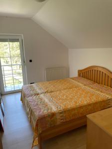 a bedroom with a bed and a large window at 069 Riverside Vikendica - Banja Luka in Rekavice