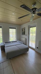 a bedroom with two beds and a ceiling fan at 069 Riverside Vikendica - Banja Luka in Rekavice