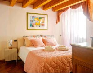 a bedroom with a bed with two towels on it at Piccolo Mondo Antico in Verona