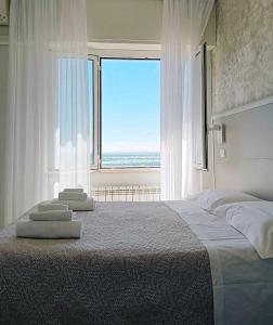 a bedroom with a large bed and a large window at La Casa sul Mare - Monterosso - Cinque Terre in Monterosso al Mare