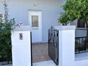 a white door with a gate in front of a house at Family House Kos Down Town in Kos Town