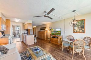 a living room with a couch and a table at Maui Sunset in Kihei