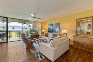 a living room with a couch and a table at Maui Sunset in Kihei