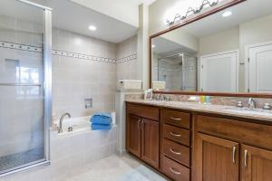 a bathroom with a tub and a sink and a shower at Five Star Waikoloa Beach Villa, Golf & Lake Views in Waikoloa +31 photos