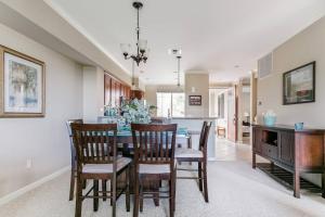 a dining room and kitchen with a table and chairs at Five Star Waikoloa Beach Villa, Golf & Lake Views in Waikoloa