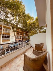 a balcony with chairs and a view of a building at Lisbon Soul Surf Camp in Cascais