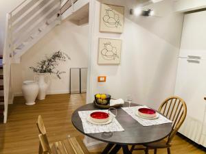 a dining room with a table and chairs at Lavica Di Mezzo Apartments in Catania