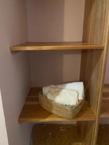 a shelf with two towels and a basket on it at Maasaifari Moshi 36 in Moshi