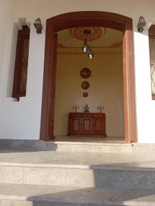 an entry way to a building with a wooden door at dar hamra in Mejlaou