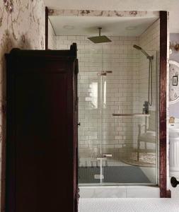 a shower with a glass door in a bathroom at Sandbank Cottage in Creal Springs +83 photos