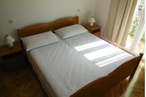 Postel nebo postele na pokoji v ubytování Apartments Maslina
