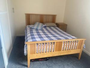 a small bedroom with a bed with a blue and white checkered sheets at Renton Residence in Renton