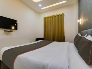 a hotel room with a bed and a television at Hotel Iconic Stay in Indore