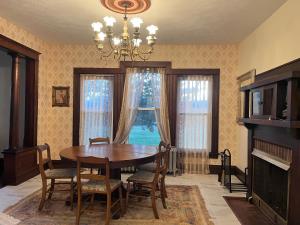 a dining room with a table and chairs and a chandelier at Sandbank Cottage in Creal Springs