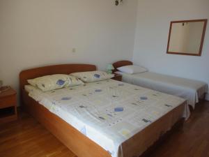 Postel nebo postele na pokoji v ubytování Apartments Maslina