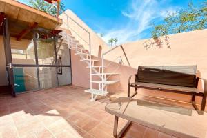 a patio with a spiral staircase and a table at Casa La Luz #2 Private One- bedroom Apartment with Full Kitchen and Private Roof Terrace in San Miguel de Allende