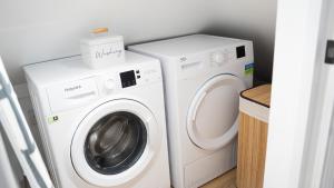 a laundry room with a washer and dryer at Oakleigh House, 3 bedroom, free parking in East Barnet