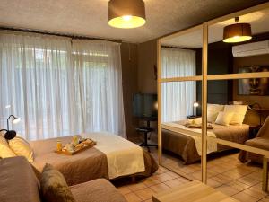 una camera d'albergo con due letti e uno specchio di Entre Paris et Disneyland Studio avec terrasse privée a Gagny