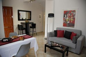 a living room with a couch and a table at NK Dreamy Suite in Thiva
