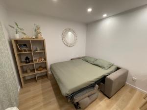 a small bedroom with a bed and a mirror at Neto Pinto - Casa de férias / fins de semana. in Lourinhã +39 photos