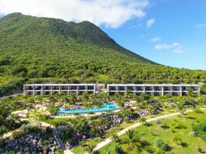 an aerial view of the resort with a mountain in the background at Golden Rock Dive and Nature Resort in Oranjestad