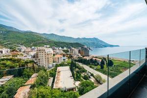 a view of a city and the water from a balcony at Skyline Apartments by In Property in Bečići