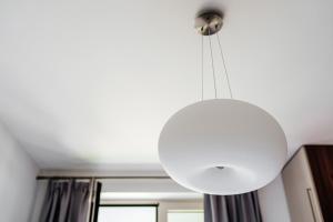 una gran lámpara blanca colgando del techo en Skyline Apartments by In Property en Bečići