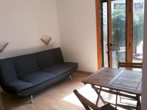 a living room with a couch and a table at Holiday Home El Romani in Calafell