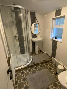 a bathroom with a shower and a sink at mountcollyer house in Belfast