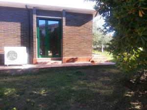 a brick house with a door and a window at Holiday Home El Romani in Calafell
