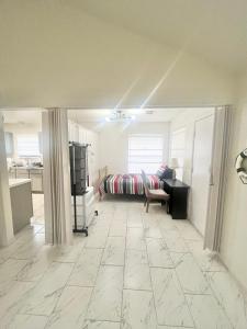 a living room with a bed and a room with a tiled floor at Rooms in Houston Texas Home Near Hobby Airport in Houston