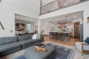 a living room with a couch and a kitchen at Bright & Spacious 4br Luxury Townhome Near Historic Park City W Fireplace & Hot Tub Noahs Retreat By Boutiq in Park City