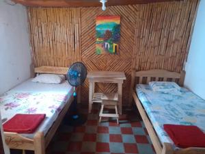 a small room with two beds and a table at Hostel Sultan in Granada