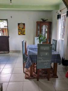 a dining room with a blue table and chairs at Chez GG in Toamasina